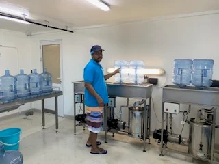 Production hall with stainless steel bottle washing and filling equipment